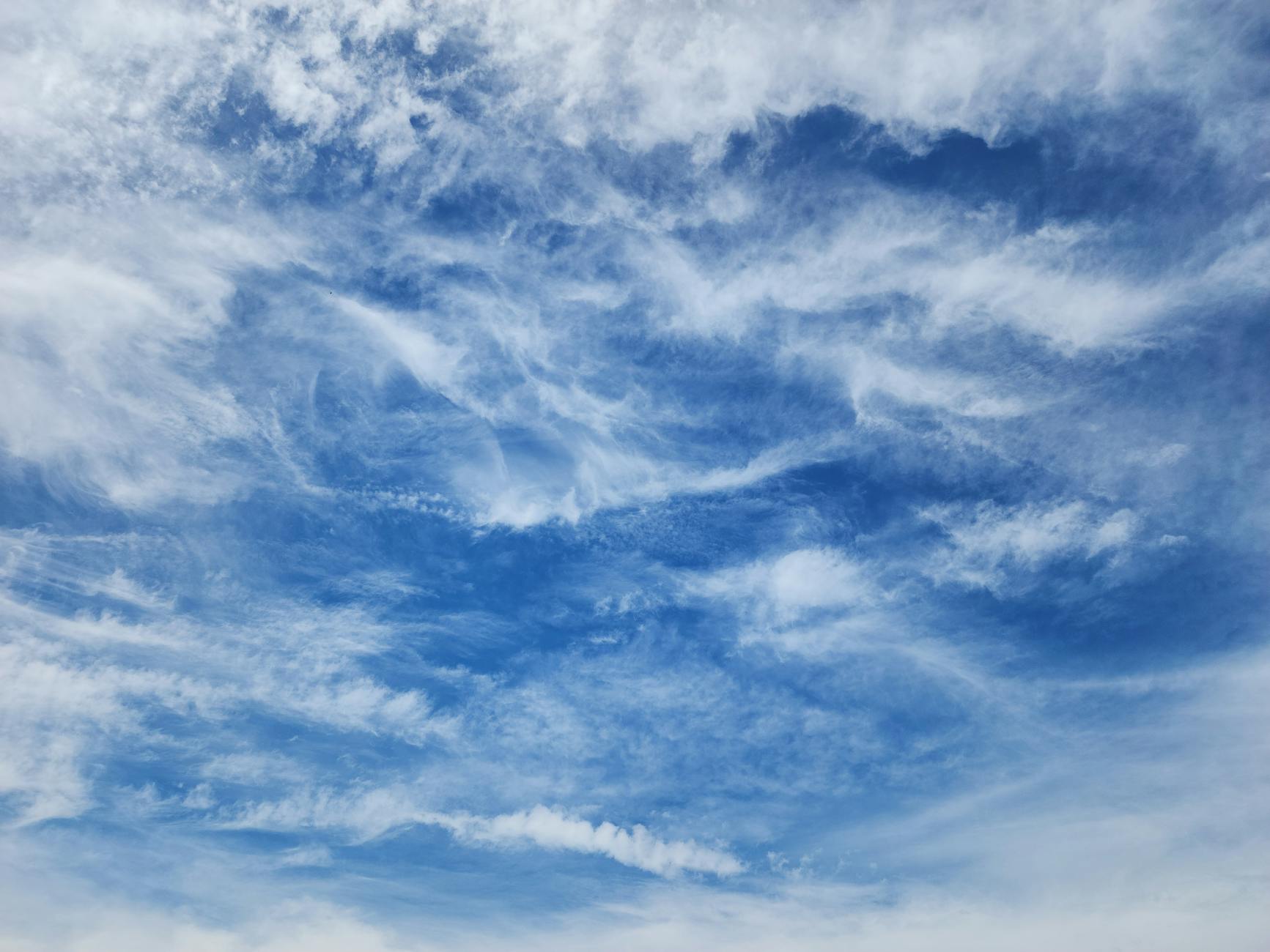 captivating blue sky with wispy clouds
